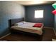 Bedroom featuring a queen bed, wood floors, and painted brick walls at 6011 N 33Rd Ave, Phoenix, AZ 85017