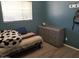 Bedroom featuring wood floors, a gray dresser, and a window with horizontal blinds at 6011 N 33Rd Ave, Phoenix, AZ 85017