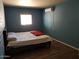 Bedroom with a queen bed, a mini-split A/C unit, and wood floors at 6011 N 33Rd Ave, Phoenix, AZ 85017