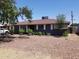 Charming single-story home with gray paint, red roof, well-manicured landscaping, and rock ground cover at 6011 N 33Rd Ave, Phoenix, AZ 85017
