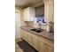 Kitchen with white cabinets, granite counters, stainless faucet, window, and grey tile backsplash at 6011 N 33Rd Ave, Phoenix, AZ 85017