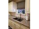 Kitchen with white cabinets, granite counters, stainless faucet, window, and grey tile backsplash at 6011 N 33Rd Ave, Phoenix, AZ 85017