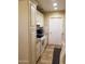 Kitchen features white cabinets, white appliances, tile floors, and granite countertops at 6011 N 33Rd Ave, Phoenix, AZ 85017