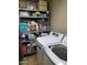 Functional laundry room featuring a washer, dryer, and ample storage shelves at 6011 N 33Rd Ave, Phoenix, AZ 85017