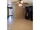 Tile living room with black media center, ceiling fan, tan walls, and view into kitchen at 6011 N 33Rd Ave, Phoenix, AZ 85017