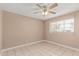 Neutral bedroom features a ceiling fan, tile floors, and a bright window view at 6334 N 37Th Ave, Phoenix, AZ 85019