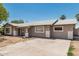 Single-story home with a neutral stucco exterior, well-defined windows and trim, with a front yard at 6334 N 37Th Ave, Phoenix, AZ 85019