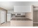 Well-organized kitchen boasting ample cabinet space, laminate counters, and an attached breakfast bar at 6334 N 37Th Ave, Phoenix, AZ 85019