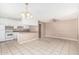 Open kitchen with white cabinetry, breakfast bar, tile floors, and a view to the living area at 6334 N 37Th Ave, Phoenix, AZ 85019