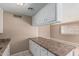 Practical kitchen featuring ample storage, laminate counters, and bar seating area at 6334 N 37Th Ave, Phoenix, AZ 85019