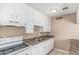 Functional kitchen featuring white cabinets, laminate countertops, and essential appliances at 6334 N 37Th Ave, Phoenix, AZ 85019