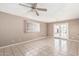 Cozy living room features tile flooring, ceiling fan, and access to the backyard at 6334 N 37Th Ave, Phoenix, AZ 85019