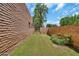 Fenced backyard with green grass and a gate, offering privacy and security at 7037 N 11Th Dr, Phoenix, AZ 85021
