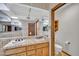 Bathroom featuring double sinks, a large mirror and tile countertops and walls at 7037 N 11Th Dr, Phoenix, AZ 85021