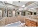 Vintage bathroom with skylights, large mirror, tiled tub and vanity at 7037 N 11Th Dr, Phoenix, AZ 85021