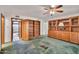 Spacious bedroom featuring built-in bookshelves, a ceiling fan and doorway access at 7037 N 11Th Dr, Phoenix, AZ 85021