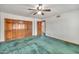 Bedroom featuring light walls, a ceiling fan, and a closet with wood doors at 7037 N 11Th Dr, Phoenix, AZ 85021