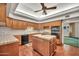 Fully-equipped kitchen with wood cabinetry, tile countertops, and modern appliances, providing a functional cooking area at 7037 N 11Th Dr, Phoenix, AZ 85021