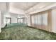 Expansive living room features green carpet, chandelier, and large windows at 7037 N 11Th Dr, Phoenix, AZ 85021
