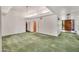 Spacious living room featuring green carpet, a chandelier and a large front door at 7037 N 11Th Dr, Phoenix, AZ 85021
