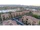 Community aerial view featuring multi-story homes with red tile roofs, street parking, and a central community at 7122 W Ivanhoe St, Chandler, AZ 85226