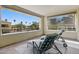 Relaxing balcony with two sun chairs and a great view of palm trees and other neighborhood rooftops at 7122 W Ivanhoe St, Chandler, AZ 85226