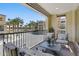 Relaxing covered balcony featuring comfortable seating and views of the community, with black metal railings at 7122 W Ivanhoe St, Chandler, AZ 85226