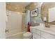 Bathroom showcasing a tub/shower combination, vanity with sink, and decorative wallpaper at 7122 W Ivanhoe St, Chandler, AZ 85226