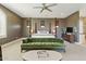Spacious primary bedroom with four poster bed, ceiling fan, seating area, and neutral decor at 7122 W Ivanhoe St, Chandler, AZ 85226
