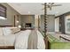 View of a main bedroom featuring a four poster bed, ceiling fan, and access to the balcony at 7122 W Ivanhoe St, Chandler, AZ 85226