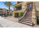 Charming home with a welcoming entrance staircase, covered balcony, and lush greenery at 7122 W Ivanhoe St, Chandler, AZ 85226