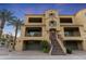 Stunning three-story home featuring multiple balconies, arched windows, and a well-manicured lawn at 7122 W Ivanhoe St, Chandler, AZ 85226