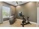 Home gym with modern exercise equipment, a ceiling fan, and light-filled window at 7122 W Ivanhoe St, Chandler, AZ 85226