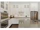 Modern kitchen featuring white cabinetry, stainless steel appliances, and sleek countertops at 7122 W Ivanhoe St, Chandler, AZ 85226