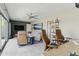 Open-concept living space with a sofa, recliners, sliding glass doors, and an adjacent home office at 7122 W Ivanhoe St, Chandler, AZ 85226