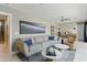 Comfortable living room with a gray sofa, leather recliner, ceiling fan, and adjacent staircase at 7122 W Ivanhoe St, Chandler, AZ 85226