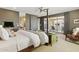 Spacious primary bedroom with a four poster bed, a sitting area, and a balcony access at 7122 W Ivanhoe St, Chandler, AZ 85226