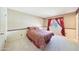 Cozy bedroom featuring carpet and red curtains that frame a window for natural light at 730 W Curry St, Chandler, AZ 85225