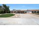 Single-story home featuring a spacious driveway and low-maintenance desert landscaping at 730 W Curry St, Chandler, AZ 85225