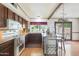 View of the kitchen that features granite counters, stainless steel appliances, wood cabinets, and breakfast bar at 730 W Curry St, Chandler, AZ 85225