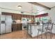 Kitchen features stainless steel appliances, wood cabinets, and a breakfast bar with barstool seating at 730 W Curry St, Chandler, AZ 85225