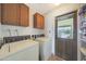 Laundry room with cabinets, washer, and dryer with a view out to the backyard at 730 W Curry St, Chandler, AZ 85225