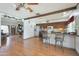Open concept living and kitchen area featuring stainless steel appliances, breakfast bar, and plenty of space at 730 W Curry St, Chandler, AZ 85225