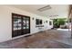 Covered back patio featuring stone flooring and views of the swimming pool through the double doors at 730 W Curry St, Chandler, AZ 85225