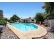 Backyard pool area featuring a refreshing in-ground pool surrounded by a pebble border and patio at 730 W Curry St, Chandler, AZ 85225