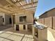 Backyard patio with built-in outdoor kitchen and pergola at 7419 S 45Th Ave, Laveen, AZ 85339