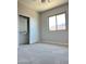 Cozy bedroom featuring plush carpeting, ample closet space, and a bright window at 7419 S 45Th Ave, Laveen, AZ 85339