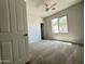 Bright bedroom features neutral carpet, ceiling fan, and a window for natural light at 7419 S 45Th Ave, Laveen, AZ 85339
