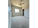 Carpeted bedroom features neutral paint, a ceiling fan, and closet at 7419 S 45Th Ave, Laveen, AZ 85339