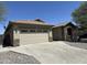 Charming home featuring a two-car garage, neutral exterior paint, and rock landscaping at 7419 S 45Th Ave, Laveen, AZ 85339